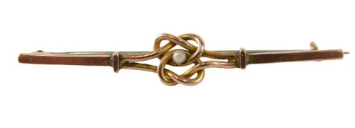 A seed pearl knot brooch, the central double knot set with single seed pearl, yellow metal, stamped 9ct, with silver coloured metal clip, 3g all in.