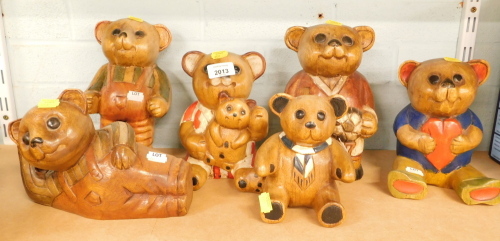 A group of carved wooden Teddy bear figures, in differing dress.