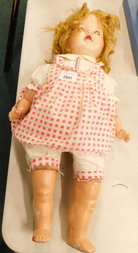 A 20thC doll, with articulated limbs and roll eyes.