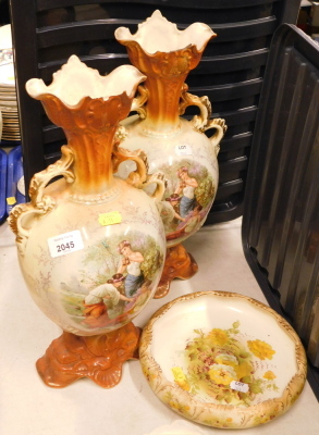 A pair of Continental two handled vases, each with a reserve depicting figures in country landscape, 42cm high, together with an SF & Co Crown Devon dish.