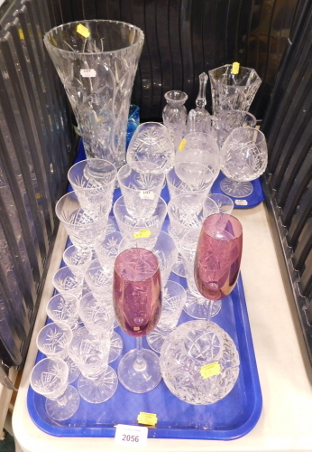 Glassware, to include a vase of cylindrical tapering form, 30cm high, drinking glasses to include brandy balloons, liqueur glasses, wine glasses, purple tinted champagne flutes, etc. (2 trays)