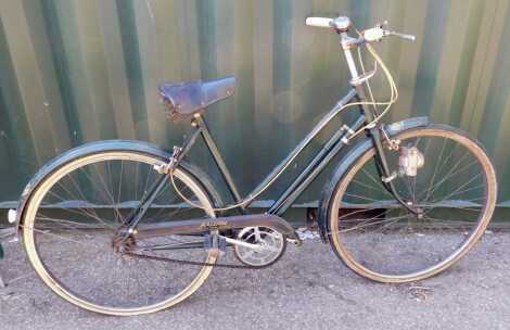 A Raleigh Triumph in British Racing Green, three speed.