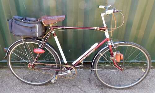 A Hercules Aston Tourist bicycle, maroon frame, three speed, with saddle bag and pump.