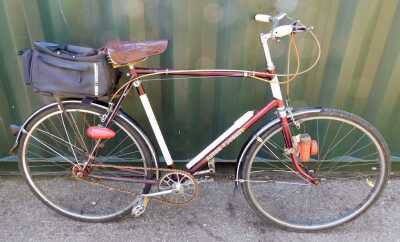 A Hercules Aston Tourist bicycle, maroon frame, three speed, with saddle bag and pump.