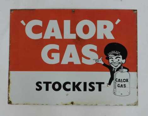 A Calor Gas enamel sign, single sided, bearing lettering Calor Gas Stockist with figure, in red, white and black, 45.5cm x 62cm.