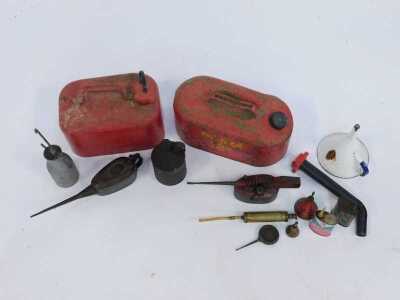 Two ready-can fuel cans, in red, together with various oil dispensers, enamel funnel, etc. - 2