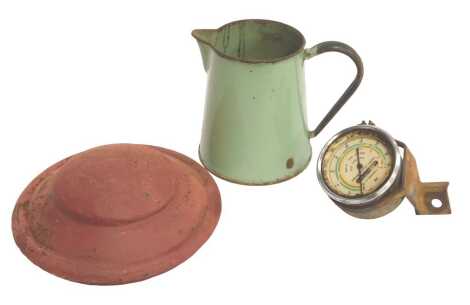 A Pulley 3100 speedometer, together with a painted red metal Ford hubcap and a green enamel jug.