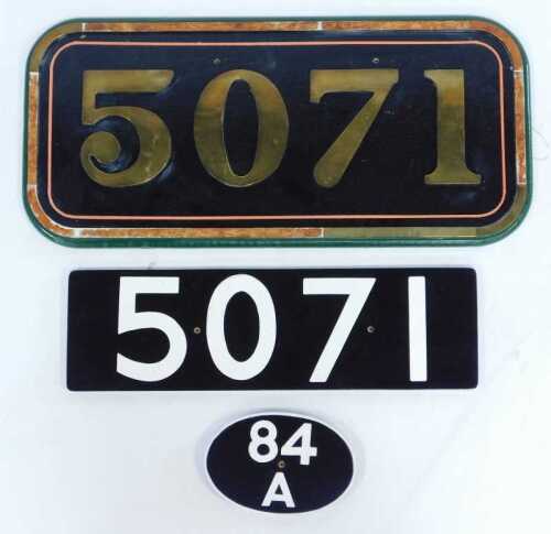 A reproduction locomotive cab side number plate, 5071, 30cm x 63cm, another, 15cm x 51cm, and an oval wagon plate 84A, 18.5cm wide.