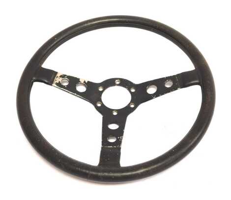 A Momo Prototipo three-spoke leather racing wheel.