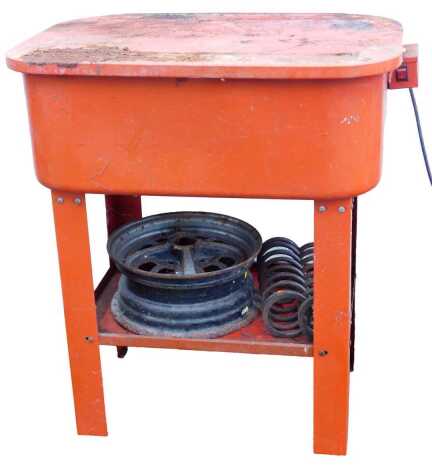 A Clarke table-mounted parts washer, alloy wheel and two suspension springs.