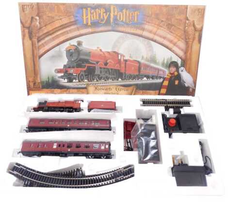 A Hornby OO gauge Harry Potter and The Philosopher's Stone Hogwarts Express electric train set, including 4-6-0 Hogwarts Castle, two BR MK1 coaches, oval track with siding, Hogsmeade Station Halt, etc., boxed R1025.