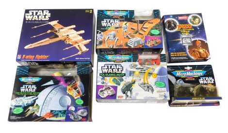 Star Wars collectables, including an Ertl AMT X Wing Fighter model kit, Micro Machines Space Star Wars Endor from Return of the Jedi, Micro Machines Space Star Wars Ice Planet Hoff from The Empire Strikes Back, Micro Machines Space Star Wars Death Star De