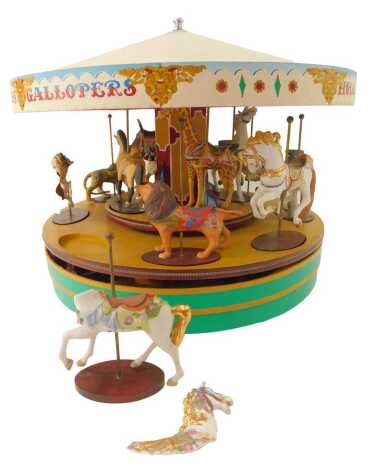 A Franklin Mint Romance model carousel, painted for advertising of Gallopers, with musical twist base, and painted ceramic horses, 28cm high, 43cm diameter. (AF)