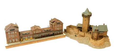 Two HO scale buildings, comprising a CAWL station mounted on wooden base, 57.5cm wide, and a Kibri Chateau de Falkenstein.