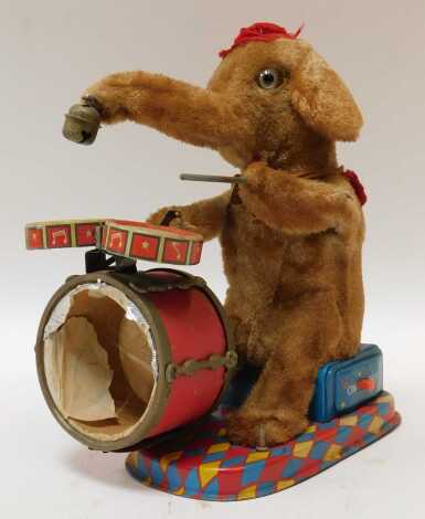 A mid century Alps battery operated drumming elephant, 24cm high. (AF)