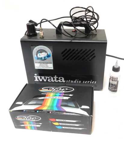 An Iwata Studio Series Smart Jet Pro airbrush compressor and a colour N Drive intelligent touch-up paint system, boxed.