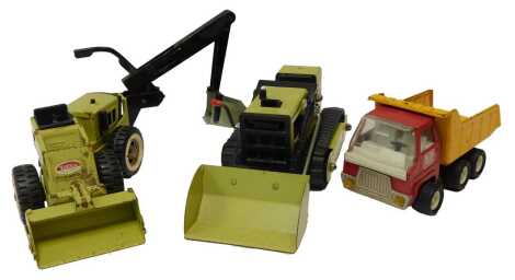 A 1970's Tonka lime green pressed steel excavator, the main body 10cm high, a Tonka lime green pressed steel Excavator, 11cm high, and a Tonka buddy mini dump truck in red and yellow, 11cm high. (3)