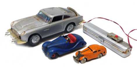 A 1960s battery operated remote control Aston Martin DB5, a Schuco Akustico 2002 tinplate clockwork car, and a Schuco 1001 tinplate clockwork car. (3)