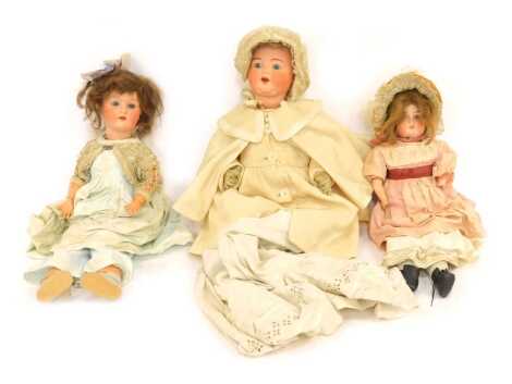 Three ceramic headed dolls, comprising an Armand Marseilles bisque headed doll stamped 996A11M, a further Armand Marseilles 250.6 bisque headed doll, and an unmarked ceramic headed doll. (3)