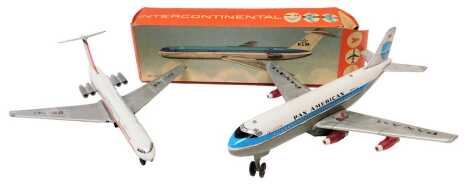 A German tin friction Intercontinental Airways plane and a Haji and Japan tinplate battery operated Pan American clipper. (2)