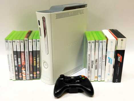 An Xbox 360, controller, leads and games including Forza Motor Sport 3, Brothers in Arms Hells Highway, Medal of Honour War Fighter, LA Noir, Alan Wake, Trivial Pursuit, Rockstar Games Table Tennis, etc. (1 box)