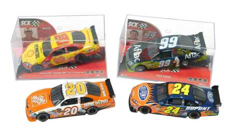 SCX and Scalextric Nascar slot cars, including Nascar number 99 Carl Edwards Ford Fusion number 99, Nascar number 29 Kevin Harvick Chevrolet Impala SS Car of Tomorrow number 29, number 20 Joey Logano the Home Depot Toyota Camri, and Scalextric C2893 numbe