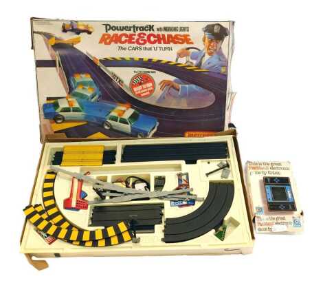 A Matchbox Power Track Race and Chase game, boxed, together with an Entex Pacman 2 game, boxed.