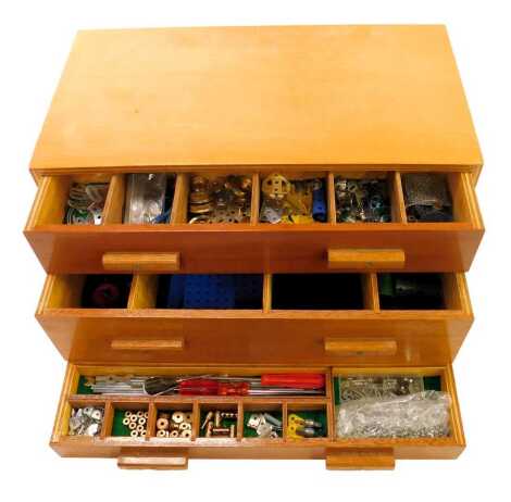 A wooden box containing Meccano gears, chains, tools, etc.