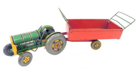 A Mettoy green tin plate tractor, 19cm long, together with a trailer.