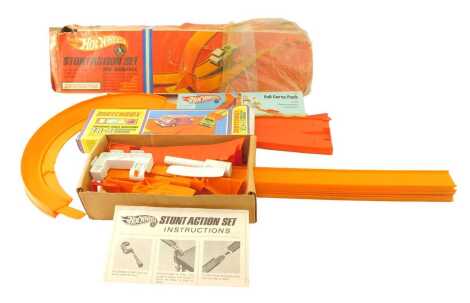 A Hot Wheels stunt action set, together with Super Fast Track accessory whiplash chicane set, and a full curved pack.