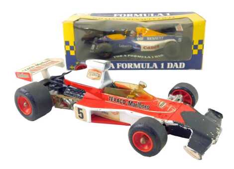 A Corgi diecast racing car of a McLaren M23B F1, together with a Hallmark Nigel Mansell's Formula 1 Williams Renault FW14, boxed.