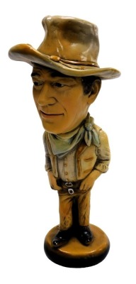 A plaster figure modelled as John Wayne, 44cm high.