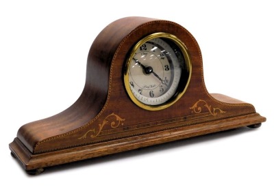 An Edwardian mahogany and inlaid mantel clock, with later battery movement, the case of Napoleon hat form, raised on brass feet, 35cm wide.