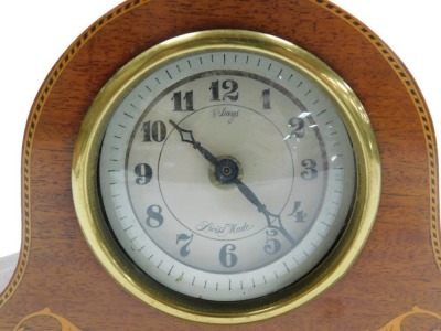 An Edwardian mahogany and inlaid mantel clock, with later battery movement, the case of Napoleon hat form, raised on brass feet, 35cm wide. - 2