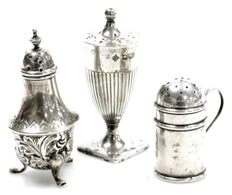 Two Victorian silver pepperettes, comprising a pepperette of baluster form embossed with flowers, Birmingham 1900, Adam style semi fluted pepperette, London 1900, and an Edwardian silver pepperette or sifter, of cylindrical form, with side handle, Birming