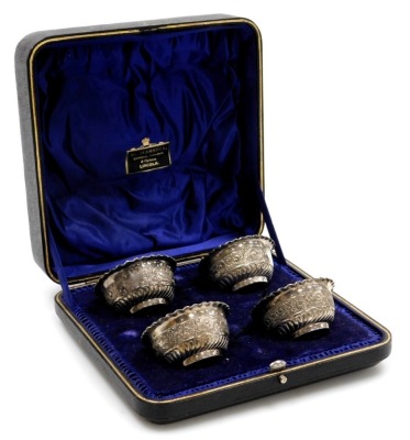 A cased set of four silver plated salts, each with a fluted border in presentation W Mansell of Lincoln box.