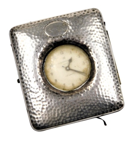 A Victorian travel watch case, with maroon leather fitment, and applied and hammered silver frontage, with a Ingersoll Triumph pocket watch, the case maker H M, Birmingham dated rubbed, 8.5cm x 9.5cm.