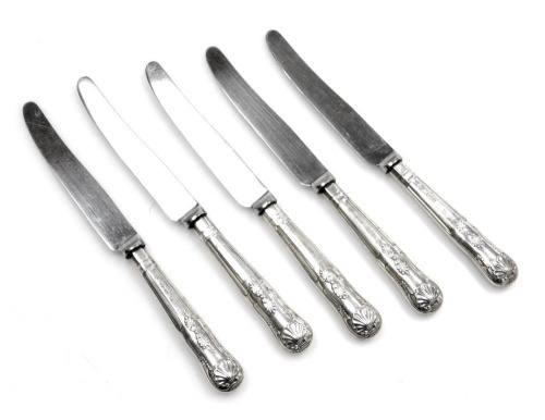 A set of five shell pattern silver handled butter knives, each with stainless steel blade.