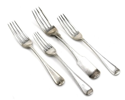 Three George III and later silver forks, comprising an Irish Old English pattern table fork, bearing arm and wheatsheaf crest, maker AM, Dublin 1808, two Walker and Hall Old English pattern starter forks, Sheffield 1910 and a further Victorian bead patter