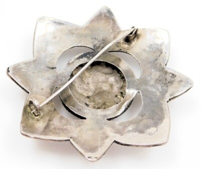 A Middle Eastern star design brooch, with raised scroll detail, set with coral, 6cm wide, white metal unmarked, 18.5g all in. - 2