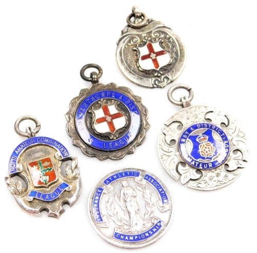 Five silver shield fobs, for the Notts Amateur Combination League, Culverthorpe and District League, Derby and District Amateur League, Insurance Athletic Association Championship, and a C&DL crest, each enamel decorated, 53.8g all in. (5)