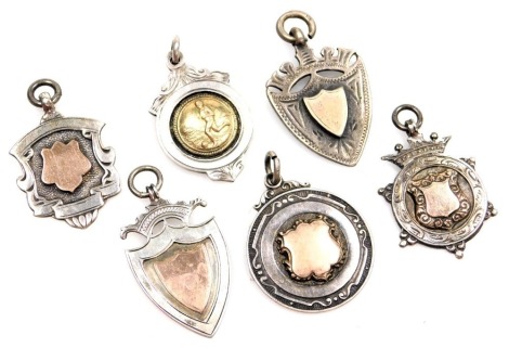 Six various silver shield fobs, each with silver gilt centre, one bearing football emblem, 52.8g all in.