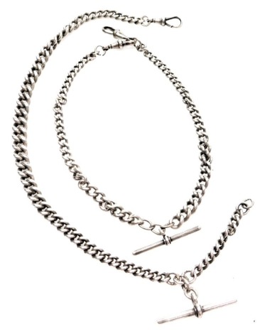 Two silver watch chains, comprising a curb link watch chain with clip and T bar, 36cm long, a further curb link bracelet with clip and T bar, 30cm long, 85.8g all in (2)