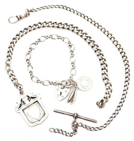 A silver charm bracelet, the twist fancy link bracelet with heart shaped padlock and safety chain, banana and Pisces charms, 14cm long, a curb link watch chain bracelet, with clip and T bar, 26cm long, and a curb link watch chain, white metal unmarked, 20