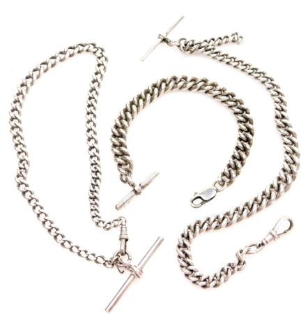 Three chains, comprising a curb link bracelet, with lobster claw clasp and T bar, 19cm long, a silver curb link watch chain with clip and T bar, 28cm long, and another 30cm long, 122.5g all in. (3)