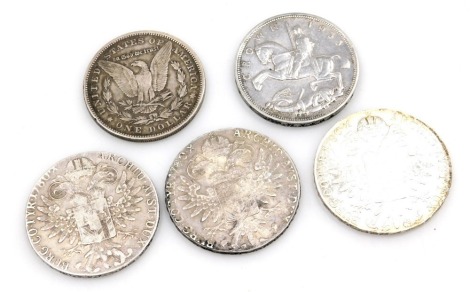 A group of Maria Theresa Thaler and other coins, comprising an 1890 dollar, three Maria Theresa Thalers 1780, and a George V Silver Jubilee 1935 crown. (5)