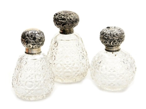 Three Edward VII silver and cut glass scent bottles, comprising London 1904, Birmingham 1903 and London 1903, the largest 13cm high. (3, AF)