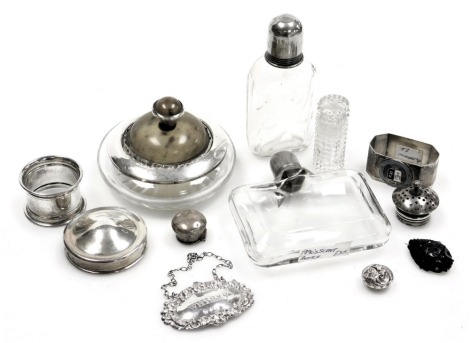 A group of cut glass and silver rimmed dressing table wares, comprising scent bottle, ashtray, hip flask, silver whisky napkin ring, plated napkin rings, silver topped, etc. (a quantity)