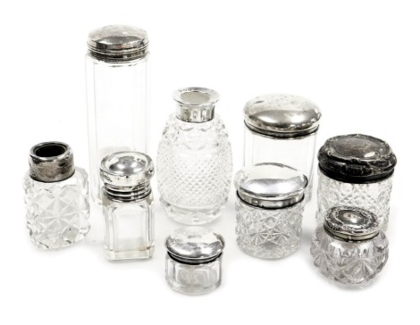 Nine silver topped and cut glass dressing table jars, varying dates, the largest 12cm high.