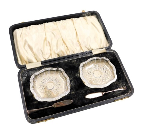 A set of Elizabeth II cut glass butter dishes, each with a silver presentation knife, Birmingham 1973, in presentation case.